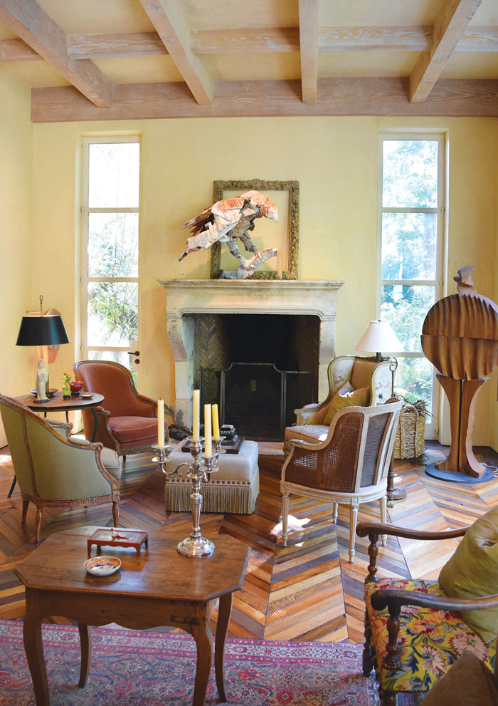 French salon chairs and limestone fireplace