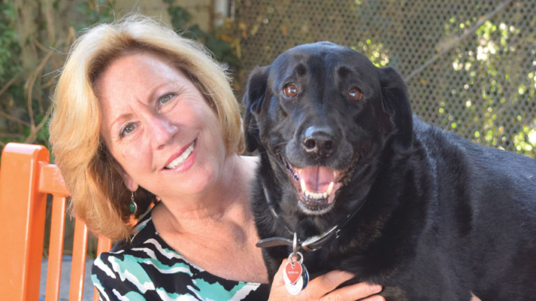 Former Shelter Leader Gina Kepp with her rescue lab Coal